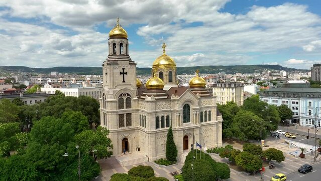 Cathedral in City center of Varna. Urban Landscape. Golden domes of the Assumption Cathedral. Aerial view. Drone rising flight around the Dormition of the Mother of God. Varna is the sea capital of Bu
