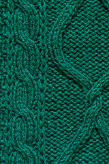 Macro green handmade woolen sweater fabric texture. Close up