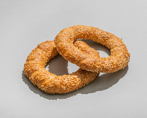 Classic Turkish baked simit  on grey background closeup
