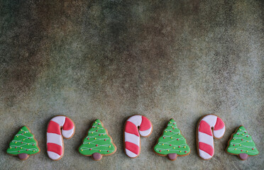 Top view of christmas cookies on gray background with space for christmas greetings. Gingerbread in...