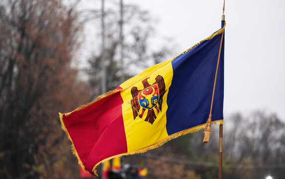 The national flag of Republic of Moldova waving in the wind against cloudy sky.