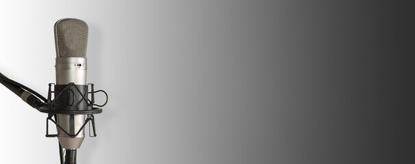 Recording studio microphone on white and grey background