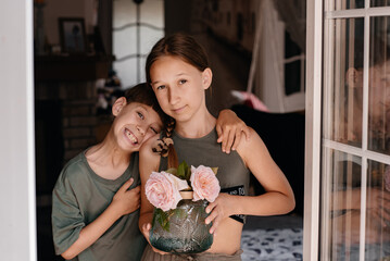 A little boy gives beautiful flowers to his little girlfriend after a serious quarrel