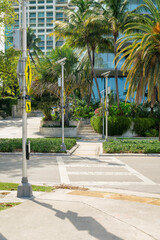 Obraz premium Crosswalk with yellow signs on the post at the side in Miami, Florida