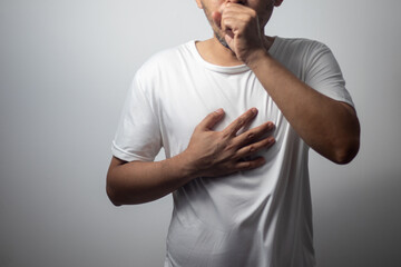 man wearing white shirt coughing on white background