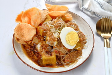 ketoprak-indonesian Traditional street food.dish of rice cake,rice noodles, bean curd, egg,boiled sprouts and served with peanut dressing.