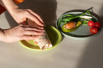 Scrambled eggs with avocado, tomatoes and herbs wrapped in a Mexican tortilla. Healthy vegan...