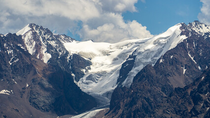 permafrost. glaciers. snowy mountain peaks and cliffs. snowy mountains in hot summer. mountain peaks in the clouds