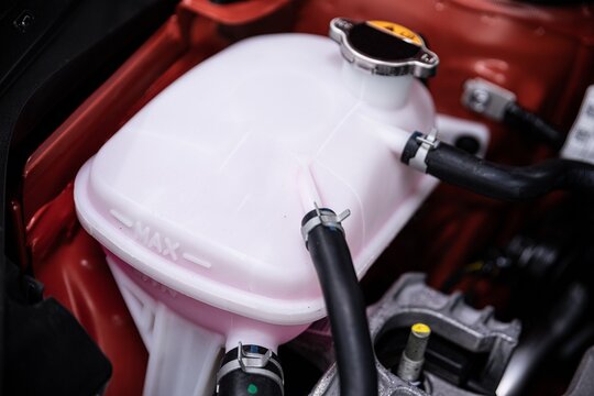 Coolant tank under the hood of a modern car. Car cooling system.