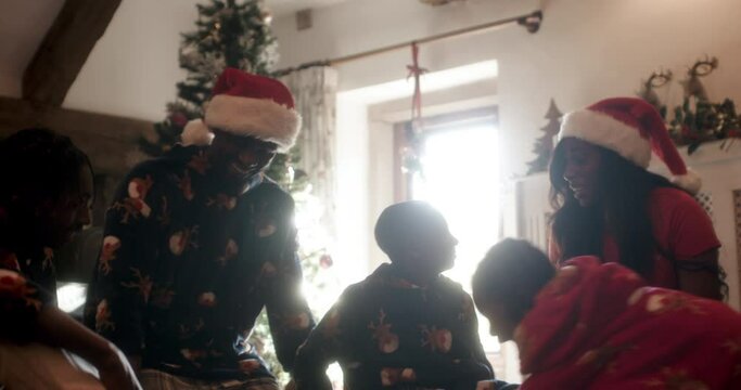 Happy family at Christmas tree in living room