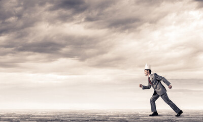 King businessman in elegant suit running and blue sky at background