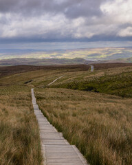 Fototapeta na wymiar Wooden trail through beautiful countryside up a mountain. Cuilcagh Boardwalk Trail in Fermanagh, Northern Ireland. Stairway To Heaven