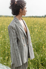 An Asian model poses in a field of yellow flowers for a clothing brand, polyethylene is the main...