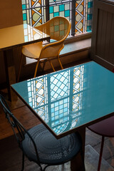 Stained glass windows let light into a cafe in a deconsecrated, restored church in Mayfair, London,...