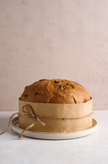 Italian panettone. Traditional italian Christmas cake on delicate background. Some ingredients are...