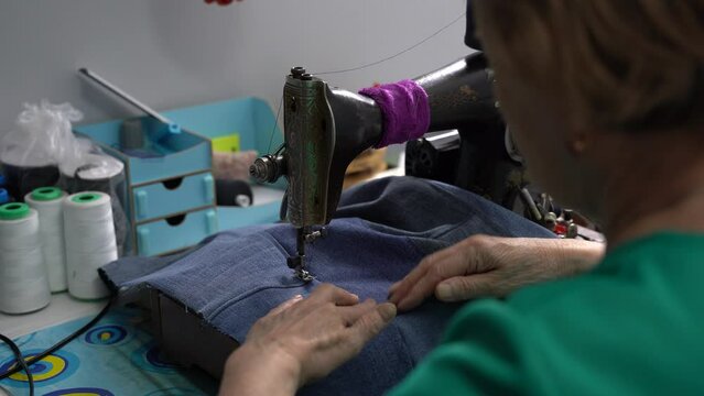 seamstress work from behind the shoulder, home production, tailor works
