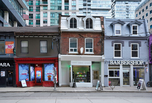 Toronto, Canada -  Colorful stores and restaurants on Queen Street West, a trendy neighborhood, in original 19th century buildings