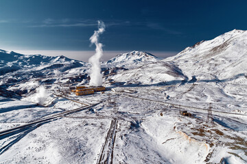 Aerial view to geothermal power plant in mountain. Clean green renewable energy in Kamchatka
