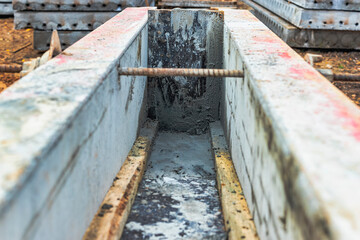 Reinforced concrete foundation of a modern monolithic residential building. Prepared formwork with reinforcing mesh for pouring concrete. Monolithic construction technologies.