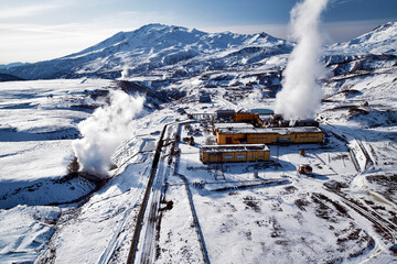 Aerial view to geothermal power plant in mountain. Clean green renewable energy in Kamchatka. - 550639633