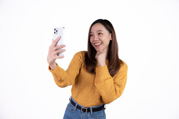 Portrait of a smiling casual asian woman holding smartphone over white background.