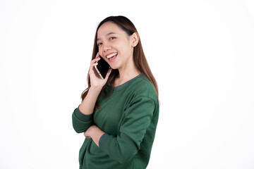 Portrait of a smiling casual asian woman holding smartphone over white background.