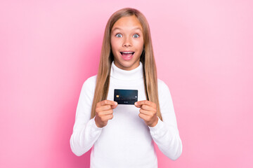Fototapeta premium Photo of impressed cute girl wear stylish outfit hand arm hold plastic debit card rejoice hooray isolated on pink color background