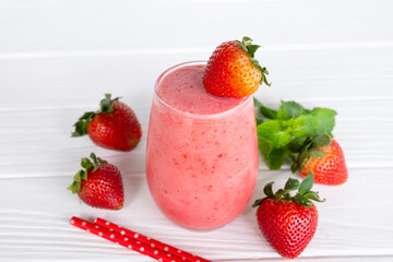 Strawberry yogurt fruit juice smoothie pink colorful fruit juice milkshake blend beverage healthy high protein the taste yummy In glass drink episode morning on white wood background.