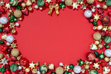 Christmas decorations toys for fir tree on red background. Merry Christmas and Happy New Year concept. Copy space for your text. Top view