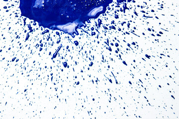 Stain of blue paint with splashes on a white background