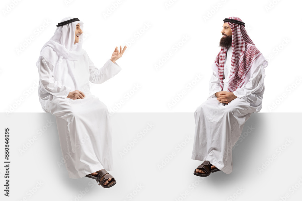 Wall mural two arab men seated on a white panel having a conversation