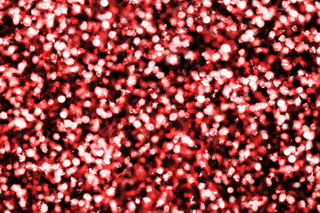 Christmas background. Red shiny background. Abstract vibrant color glowing white spots texture for graphic design. Bright yellow defocused glitter texture.