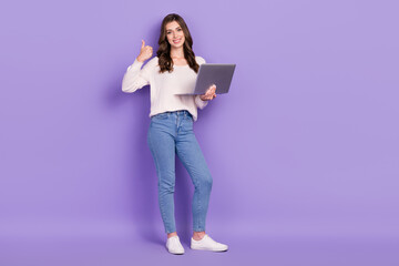 Full length photo of charming pretty lady use netbook hand thumb up satisfied modern gadget empty space isolated on purple color background