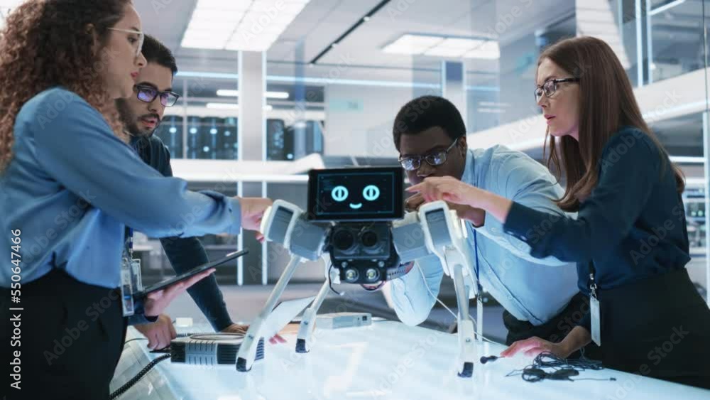 Poster Diverse Team of Industrial Robotics Specialists Gathered Around a Table With a Mobile Robot. Scientists Use Tablet and Laptop Computers to Program the Automated AI Robotic Dog.