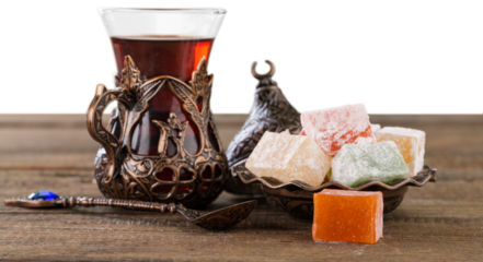 Arabic traditional sweets and berry with tea on plate