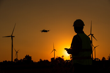 silhouette of a person control Drone on a sunset