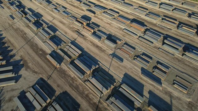 View of made steel billets and slabs in urban area of steel factory manufacturing. Steel used for production of auto EV electric motor, packaging beverage cans and construction.