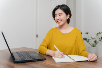 A young businesswoman is very happy after checking her email through her laptop.