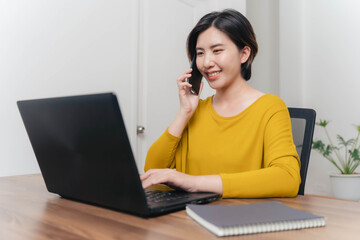 A young businesswoman is very happy after checking her email through her laptop.