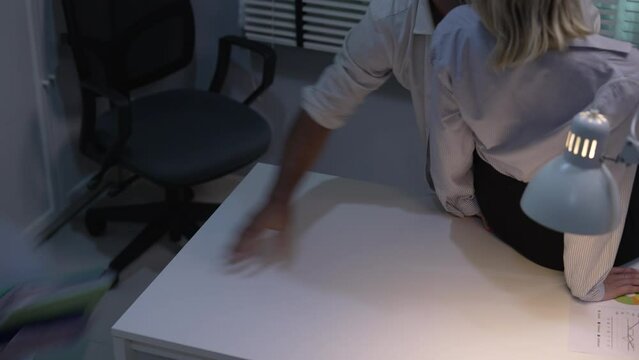 Young Caucasian couple having sex in the office.