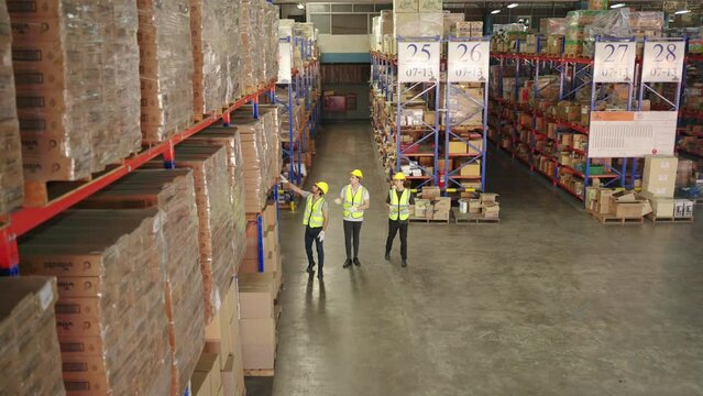 top view, warehouse worker inspecting goods placed on shelf in warehouse, warehousing, distribution, transport
