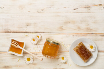 Composition with fresh honey on wooden background, top view