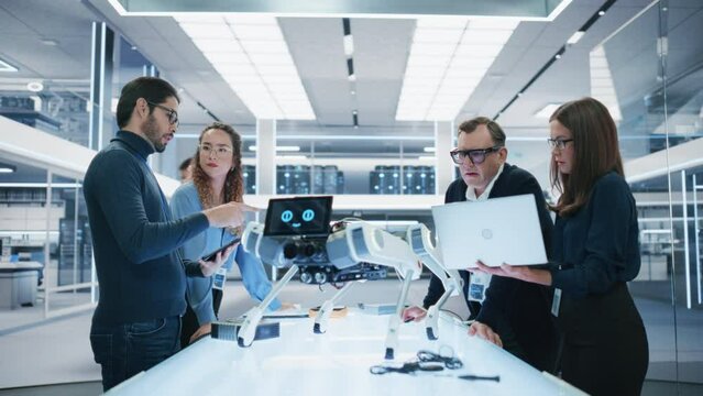 Professional Multicultural Team of Female and Male Engineers Use Industrial Programmable Robot Animal in a Factory Development Workshop. Tech Facility with Machines, Computers and Research Equipment.