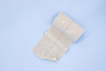 Elastic adhesive bandage on blue background
