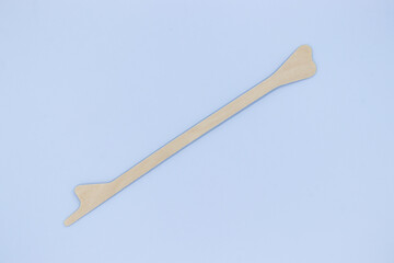 Disposable Wooden spatula on blue background, use for gynecologi