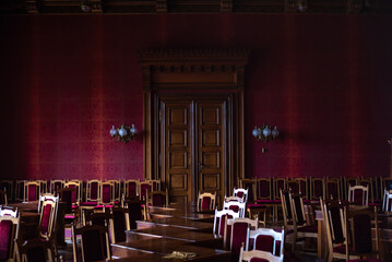 wooden chairs and tables for negotiations; 
many vintage chairs in the hall with soft upholstery;