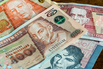Guatemala money, Various quetzal banknotes lying on the table, business and financial concept