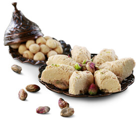 Bronze plate with date nuts and arabian sweet on the background. Ramadan kareem.