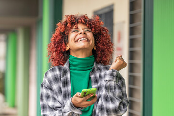 girl with mobile phone or smartphone and expression of success