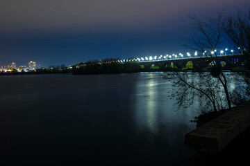 Highlighted bridge over the river at night